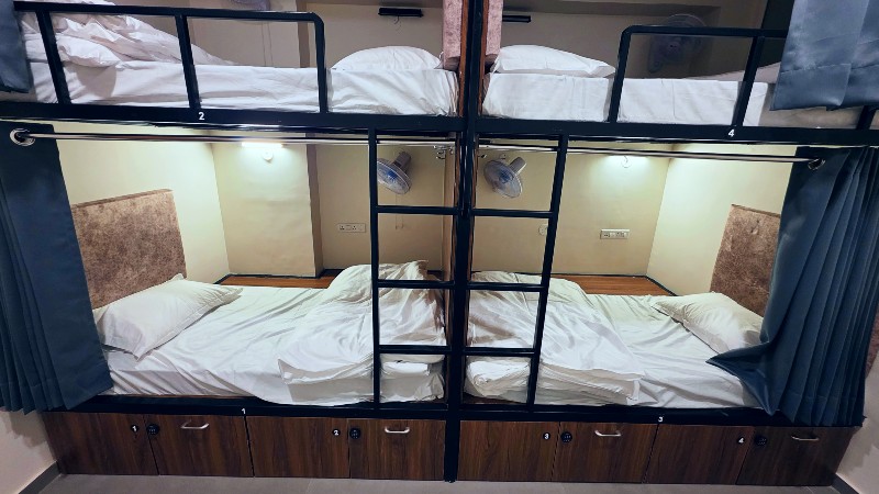 Bunk bed with privacy curtain at Shikha Hostel Jaipur